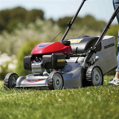 Thematic photo of a Honda petrol lawnmower cutting grass in a garden
