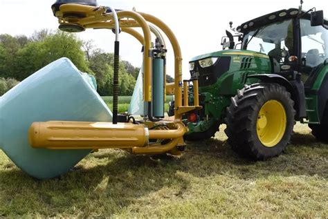 Owijarka Tanco S200 V podczas pracy, z widocznym mechanizmem owijania i ładowania bel.
