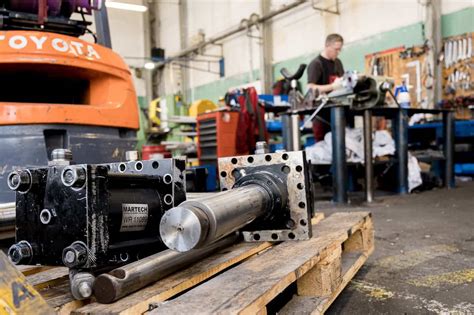 Tematyczne zdjęcie przedstawiające uszkodzoną pompę hydrauliczną Bobcat w warsztacie