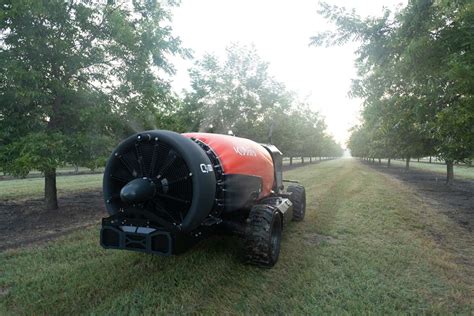 Thematic photo of an orchard sprayer working in an orchard