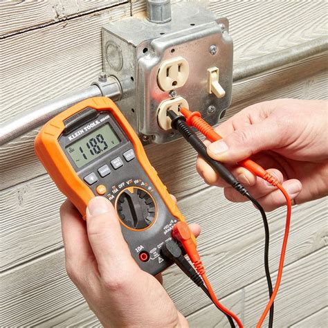 Photo of a person using a multimeter to check a capacitor