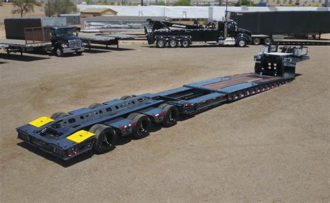 Photo of a commercial van (bus) with a trailer designed for machine transport