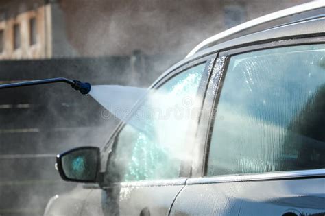 Thematic photo of a car being cleaned with a pressure sprayer