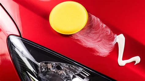 Photo of car waxing process with a sprayer