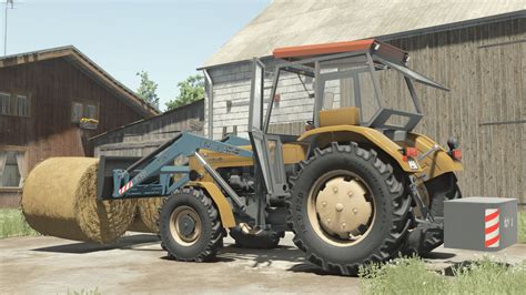 Thematic photo of a URSUS TUR front loader attached to a tractor in a field