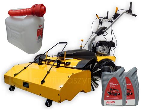 Zamiatarka z pojemnikiem JCB w akcji, ze schematem budowy i zaznaczeniem silnika hydraulicznego i systemu pływającej ramy.