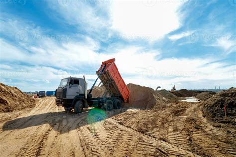 Thematic photo of a delivery tipper on a construction site unloading sand