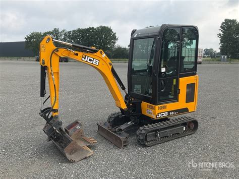 Photo of a JCB 16C-1 mini excavator with various attachments
