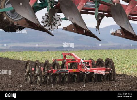 Thematic photo of a Kverneland plow in action in a field, showing soil being turned over