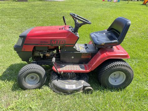 Thematic photo of an MTD lawn tractor working in a large garden