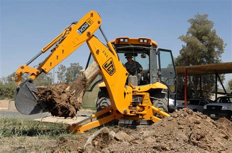 A JCB 3CX backhoe loader performing excavation work on a construction site.