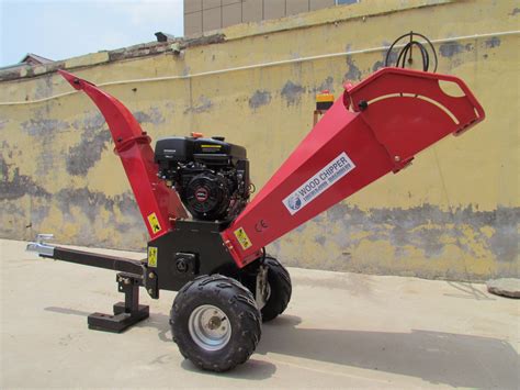 The Faworyt JR196L WB petrol shredder in a garden setting, processing branches.