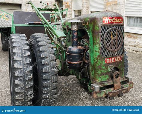 Thematic photo of a person operating a single-axle tractor in a garden