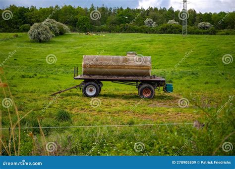 Thematic photo of a Pomot tanker in a field or pasture, potentially with animals nearby