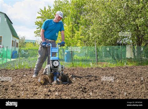 Thematic photo of a person using a tiller in a garden