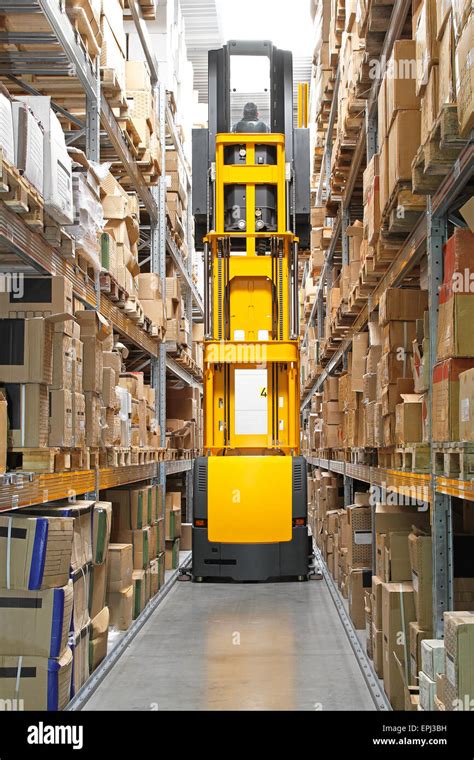Thematic photo of a forklift lifting a load in a warehouse with high shelves