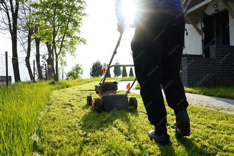 Thematic photo of a person mowing a lawn with an Alpina lawnmower