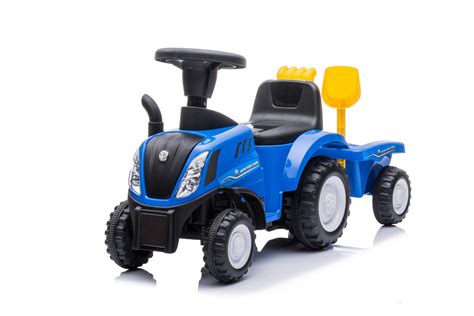 Zabawkowy traktor jeździk New Holland w niebieskim kolorze z przyczepką i narzędziami