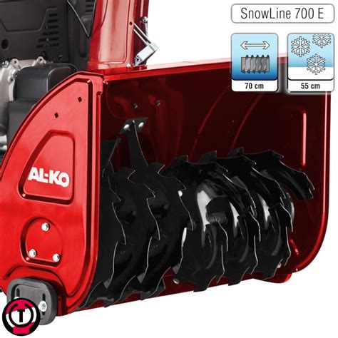 Photo of AL-KO SNOWLINE 700.4 E in action, clearing snow at night with LED lights