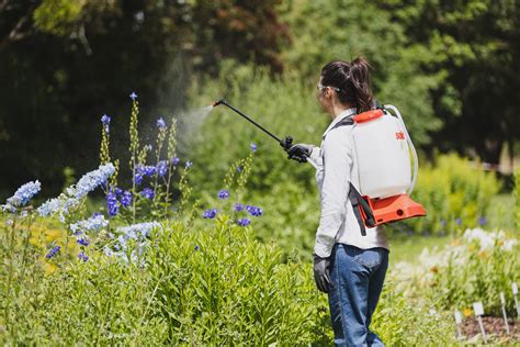Thematic photo of a person using a backpack sprayer in a garden or field