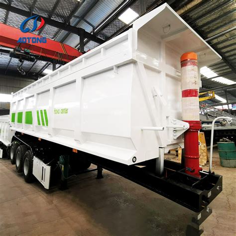 Thematic photo of a 2-axle tipper semi-trailer in operation, unloading bulk materials.