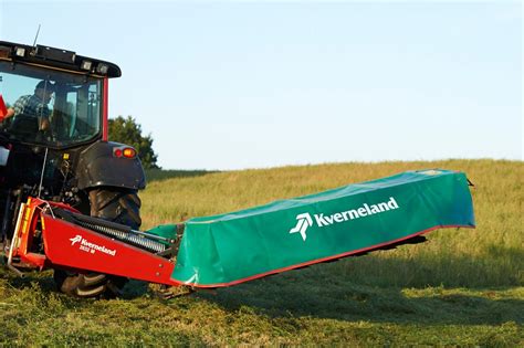 Photo of a Kverneland Taarup mower in its hydraulically folded transport position