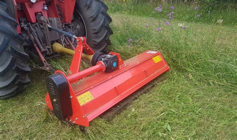 Thematic photo of a flail mower with a basket attached to a tractor