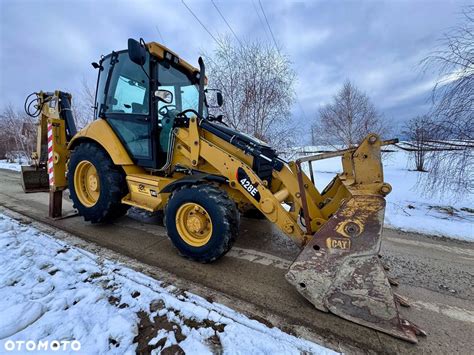 Zdjęcie przedstawiające nowoczesną koparko-ładowarkę Caterpillar w trakcie prac budowlanych