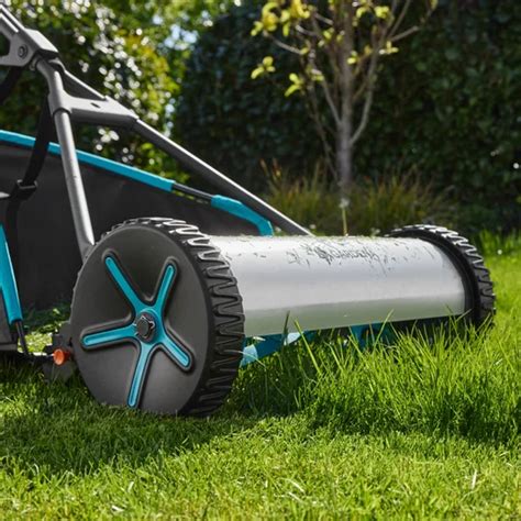 The Gardena 400 reel lawnmower in action on a green lawn, showing its compact design and large wheels