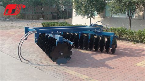 Thematic photo of a semi-mounted disc harrow working in the field