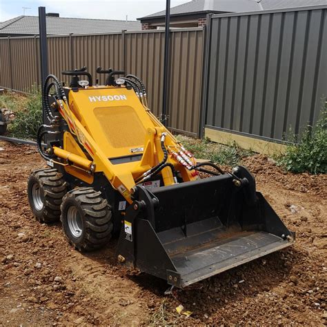 Thematic photo of a compact mini loader working in a tight urban construction space