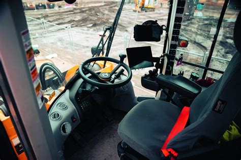 Infographic showing ergonomic features of a modern mini loader cabin