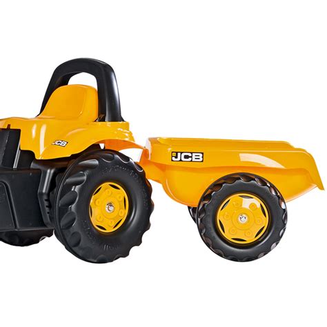 The Rolly Toys Rolly Kid JCB pedal tractor with a scoop and trailer in action, driven by a child.