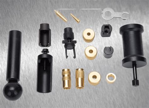 Photo showing a set of specialized keys and tools for dismantling injectors from popular car engines, including extractors for heat shields and sealing washers.