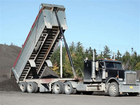 Thematic photo of a dump truck or tractor with a dump trailer in operation
