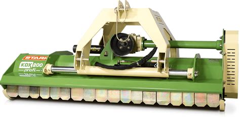The Stark KDX flail mower in action, showing its robust construction and ability to handle dense vegetation. The image should highlight the cutting mechanism and the quality of mulching achieved.