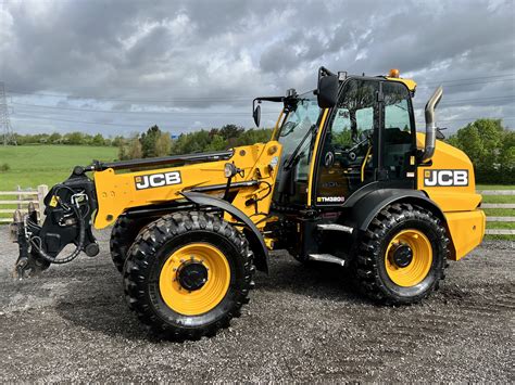Photo of a JCB TM 320S Agri articulated telehandler in action