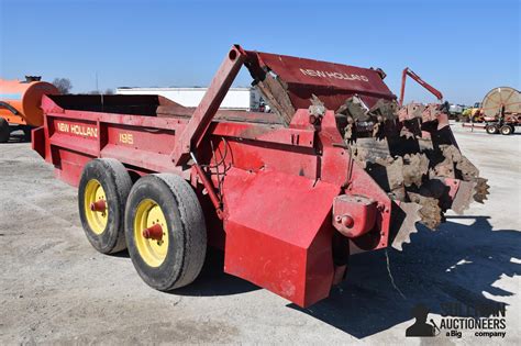 Photo of various manure spreader models lined up at a dealership
