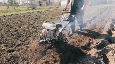 Thematic photo of a DEMON M83260 tiller in action, preparing soil