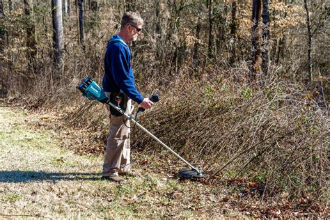 The FLO 1800W 79672 brushcutter in use, showing its design and main components.