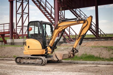 Thematic photo of a person operating a mini excavator on a construction site