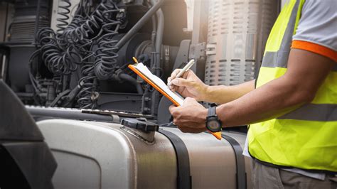 Photo of a service technician inspecting a field sprayer with diagnostic equipment