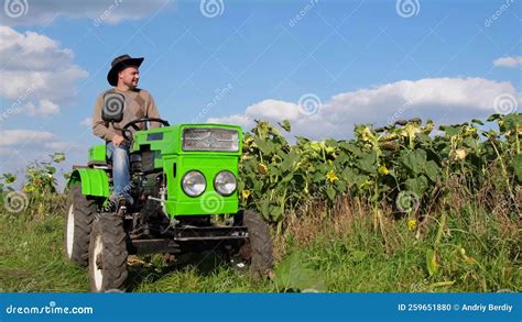 Thematic photo of a young farmer on a tractor