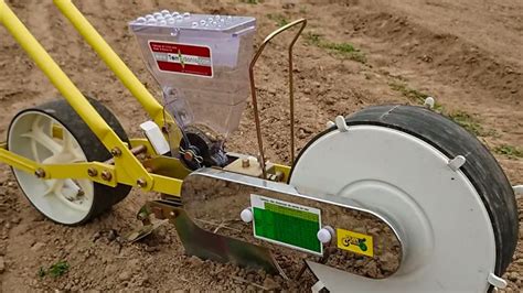 Thematic photo of a Greenmill seeder made of durable plastic in a garden setting