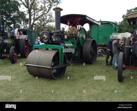 Historical photo of a steam road roller at work