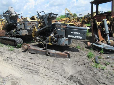 Komatsu PC 50 MR-2 pracująca na placu budowy w zapylonym środowisku