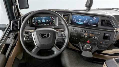 A detailed view of the interior of a modern MAN truck cabin, highlighting ergonomic design and technological features.