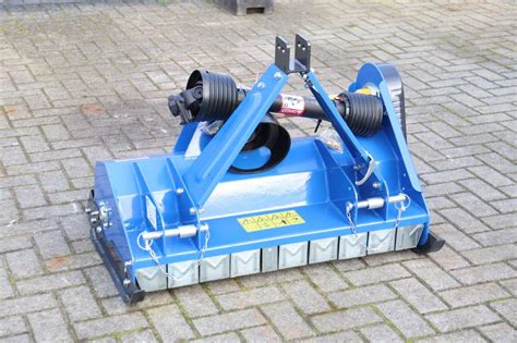 Thematic photo of a flail mower model EFN 95 attached to a small tractor working in the field