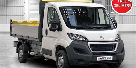 Thematic photo of a white Peugeot Boxer tipper truck parked on a construction site