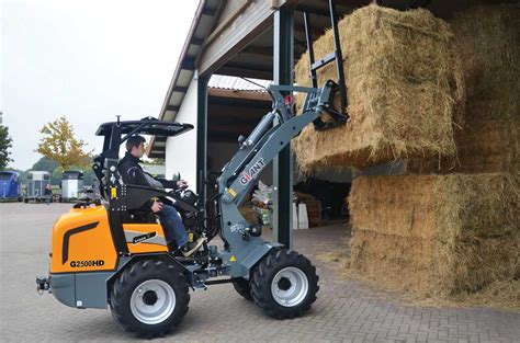 Photo of a TOBROCO-GIANT mini loader in a farm setting